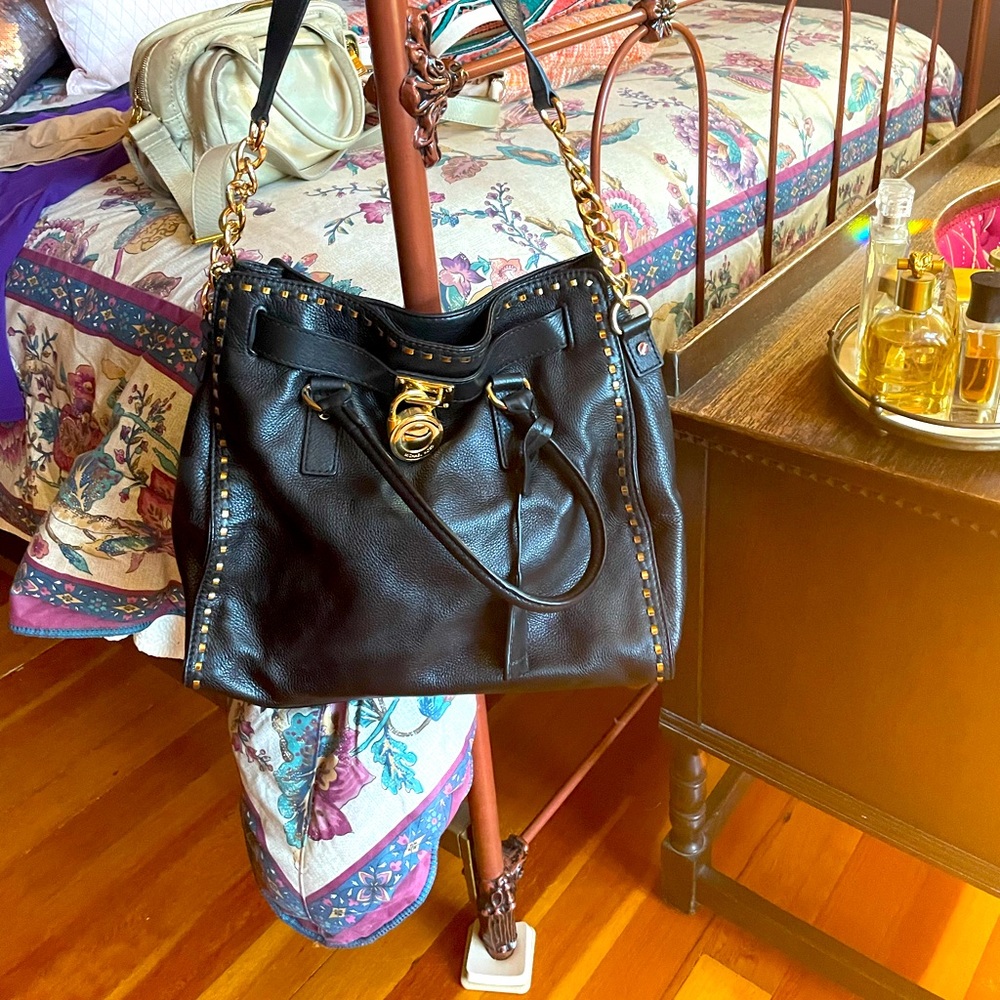 Michael Kors, black leather handbag gold, trim, and shoulder strap like new
